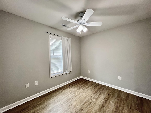 402 Pine St, Pulaski, TN 38478 - empty room featuring dark wood-style flooring, baseboards, and a ceiling fan