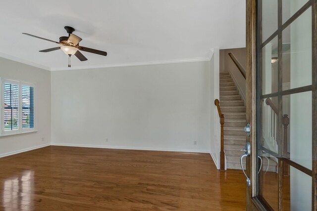 unfurnished living room featuring ornamental molding, baseboards, ceiling fan, and wood finished floors
