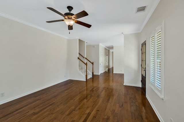 interior space featuring wood finished floors, ornamental molding, ceiling fan, and visible vents