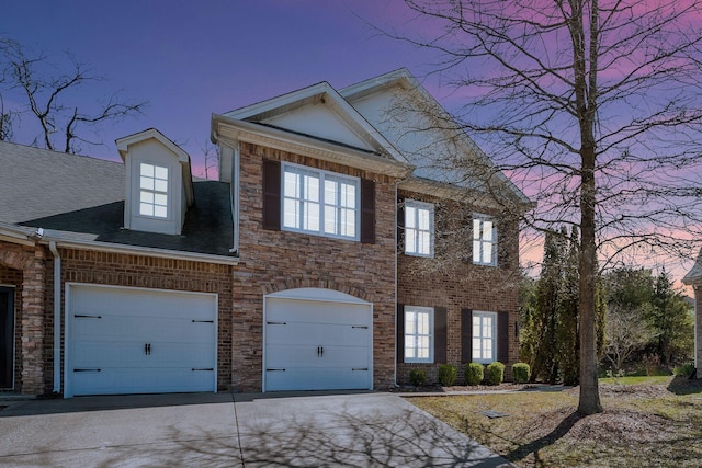 view of front facade featuring an attached garage and concrete driveway
