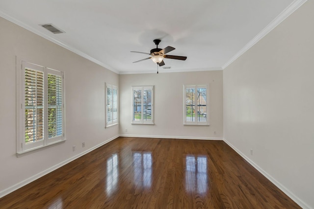 empty room featuring dark wood finished floors, crown molding, ceiling fan, and visible vents