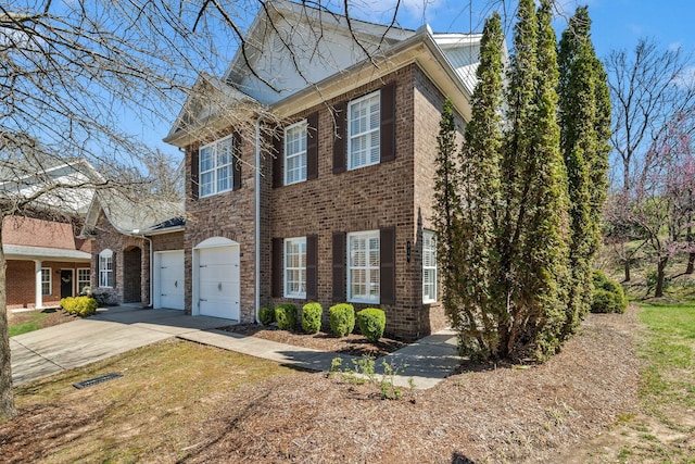 view of front of property featuring metal roof, a garage, brick siding, and concrete driveway