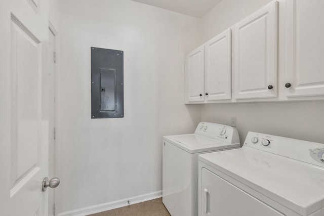 laundry area with baseboards, washing machine and dryer, electric panel, and cabinet space