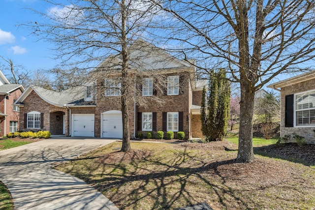 view of front of property featuring a garage, brick siding, and concrete driveway