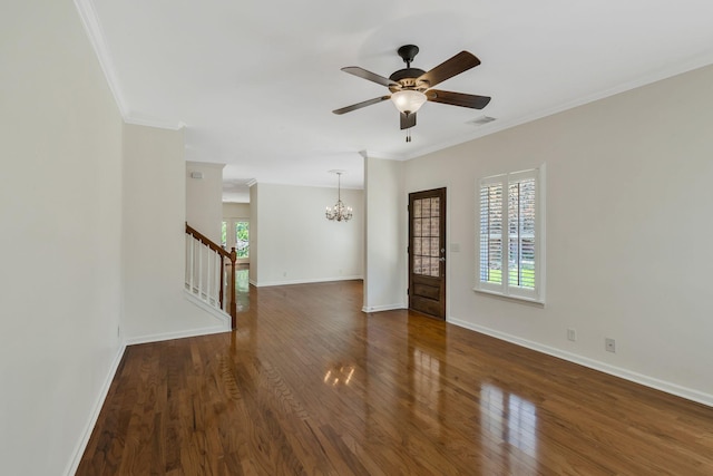 empty room featuring stairs, ornamental molding, visible vents, and hardwood / wood-style flooring