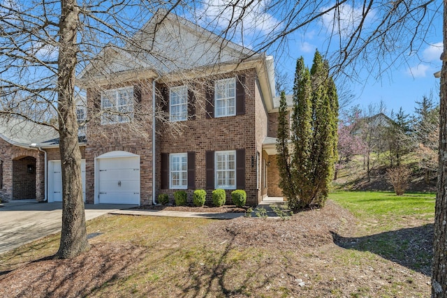 view of front of home with driveway, a front yard, a garage, and brick siding