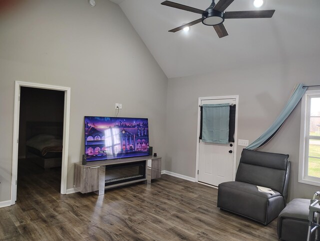 living room with dark wood-style floors, high vaulted ceiling, ceiling fan, and baseboards