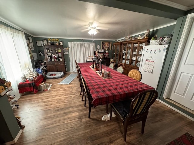 dining room featuring a ceiling fan, crown molding, and wood finished floors