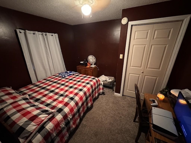 carpeted bedroom with a closet and a textured ceiling