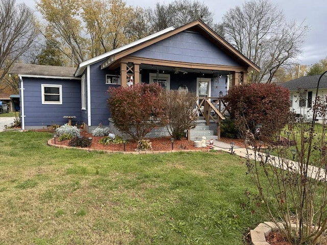 view of front of property featuring a front lawn, crawl space, and a porch