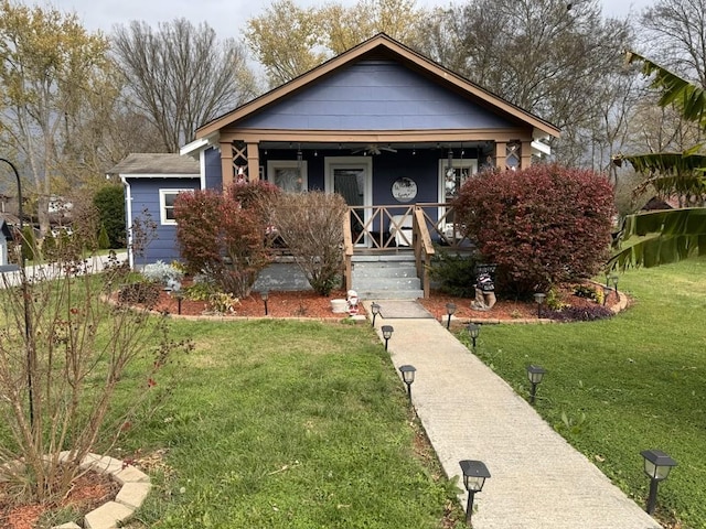 bungalow with a porch and a front yard