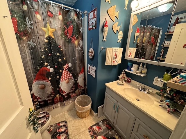 bathroom with tile patterned floors, vanity, and a shower with curtain