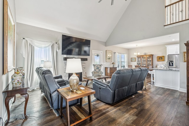 120 Sideview Rd, Gallatin, TN 37066 - living room with a stone fireplace, dark wood-style floors, high vaulted ceiling, and an inviting chandelier