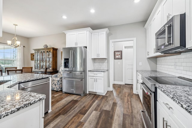 120 Sideview Rd, Gallatin, TN 37066 - kitchen featuring white cabinets, stainless steel appliances, dark wood-style floors, and a chandelier