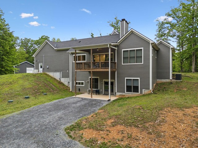 6033 Vesper Way E, Franklin, TN 37064 - back of property featuring a chimney, a lawn, a patio area, a deck, and cooling unit