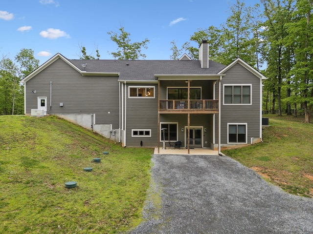 6033 Vesper Way E, Franklin, TN 37064 - rear view of house featuring a chimney, a patio, and a lawn