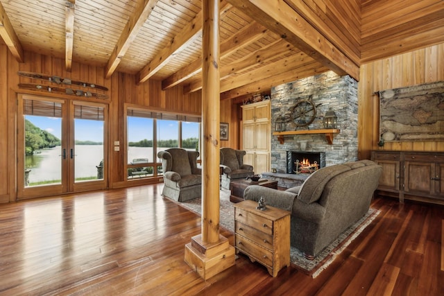 living room with lofted ceiling with beams, a fireplace, dark wood-type flooring, wooden ceiling, and wood walls