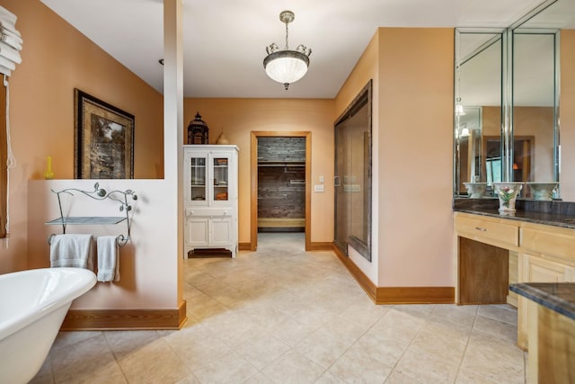 full bathroom with baseboards, a soaking tub, a stall shower, and vanity