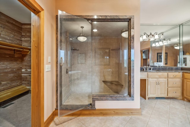 bathroom with a shower stall, tile patterned flooring, and vanity
