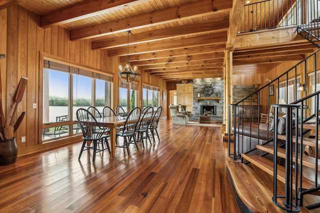 dining room with wooden walls, stairs, beamed ceiling, hardwood / wood-style floors, and wooden ceiling