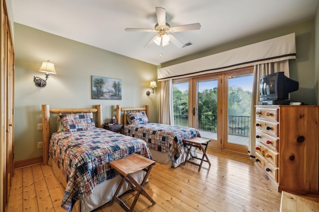 bedroom featuring visible vents, baseboards, light wood-type flooring, a ceiling fan, and access to outside