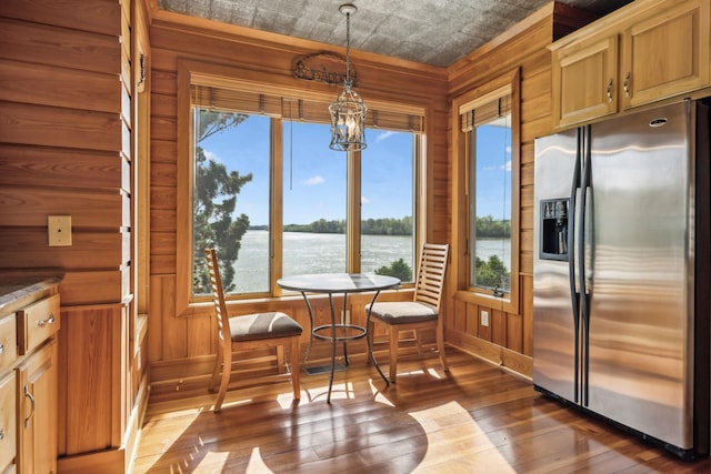 dining space with a healthy amount of sunlight, dark wood-style floors, and an ornate ceiling