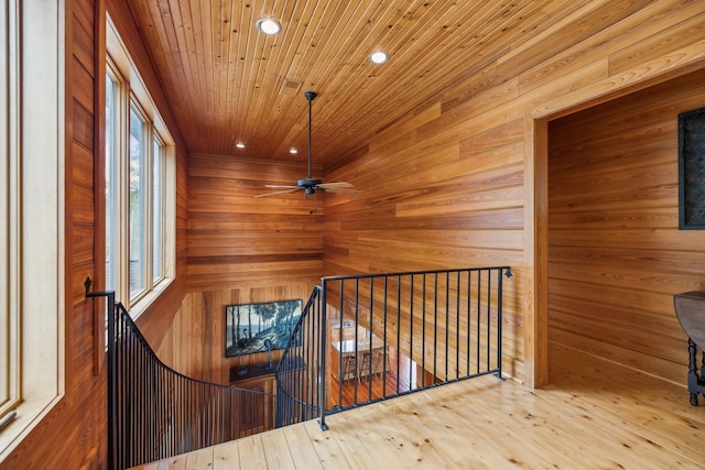 interior space featuring recessed lighting, an upstairs landing, wood walls, hardwood / wood-style floors, and wooden ceiling