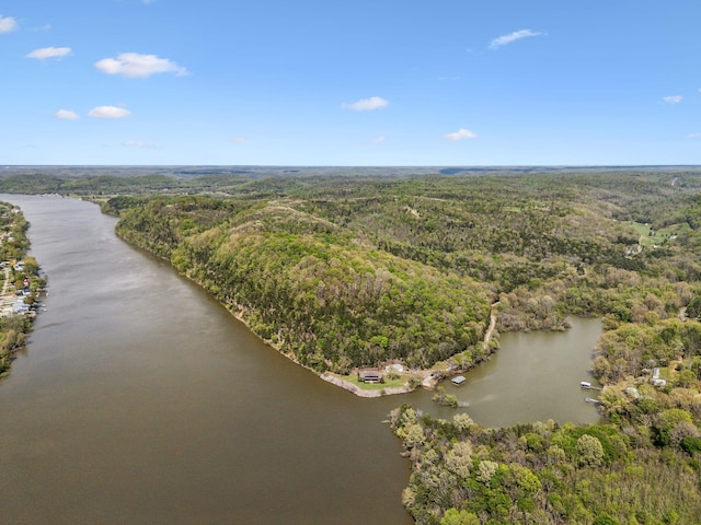 drone / aerial view featuring a water view and a forest view