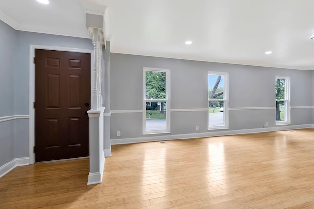 entryway with ornamental molding, baseboards, light wood-style floors, and recessed lighting