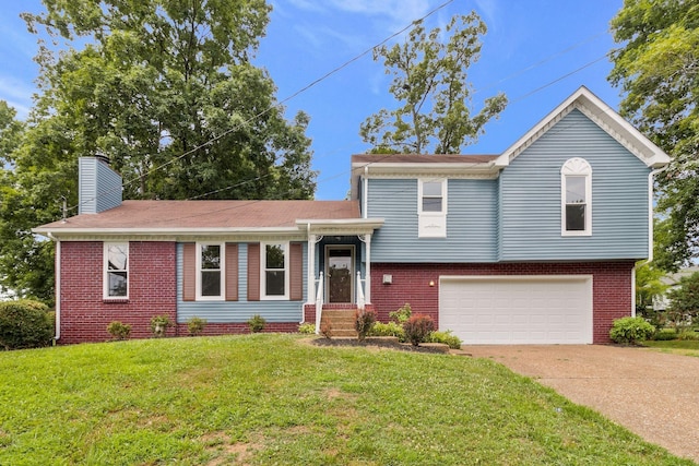 split level home with a front yard, concrete driveway, a chimney, brick siding, and a garage