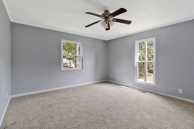 unfurnished room with baseboards, ceiling fan, visible vents, and carpet
