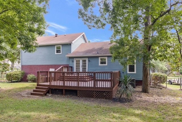 rear view of house with french doors, fence, a yard, and a wooden deck