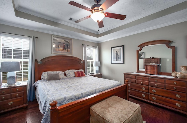 bedroom featuring a textured ceiling, visible vents, crown molding, a raised ceiling, and dark wood-type flooring
