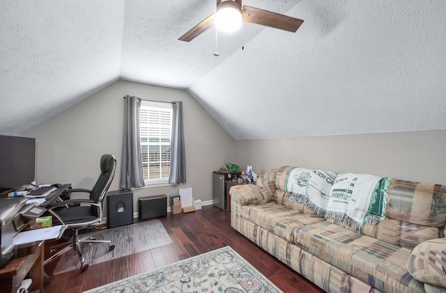home office featuring lofted ceiling, a textured ceiling, wood finished floors, and ceiling fan