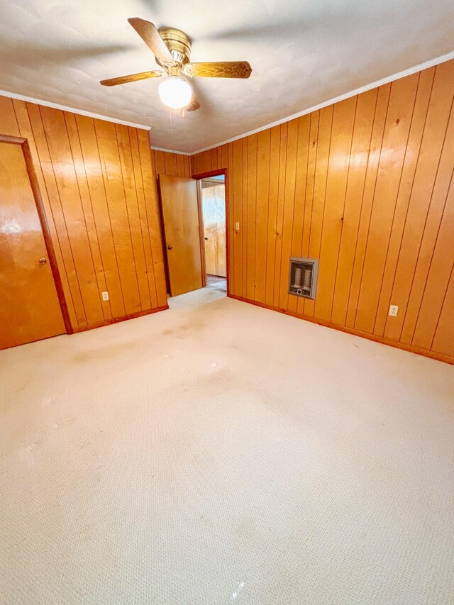 126 Zimmerman St, Hohenwald, TN 38462 - carpeted spare room with wooden walls, crown molding, baseboards, ceiling fan, and heating unit
