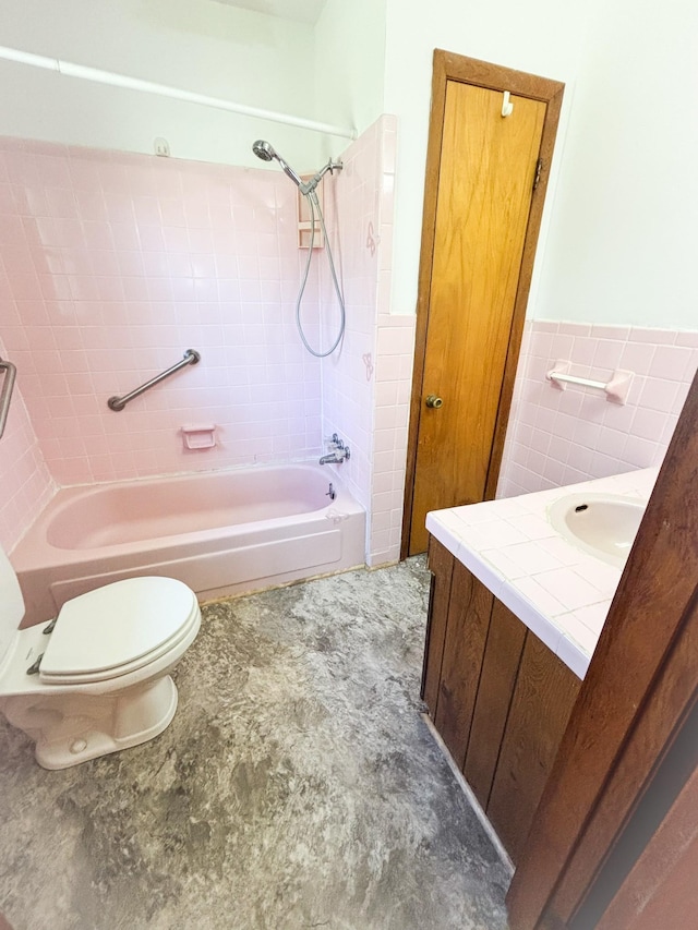 126 Zimmerman St, Hohenwald, TN 38462 - full bathroom featuring tile walls, a wainscoted wall, toilet, vanity, and shower / bathing tub combination