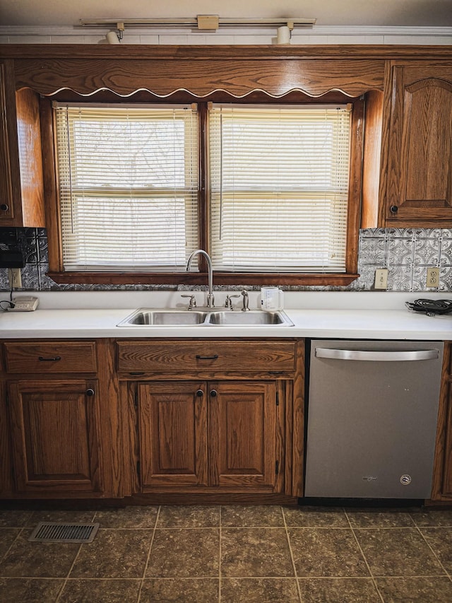 126 Zimmerman St, Hohenwald, TN 38462 - kitchen with light countertops, a sink, backsplash, dishwasher, and visible vents