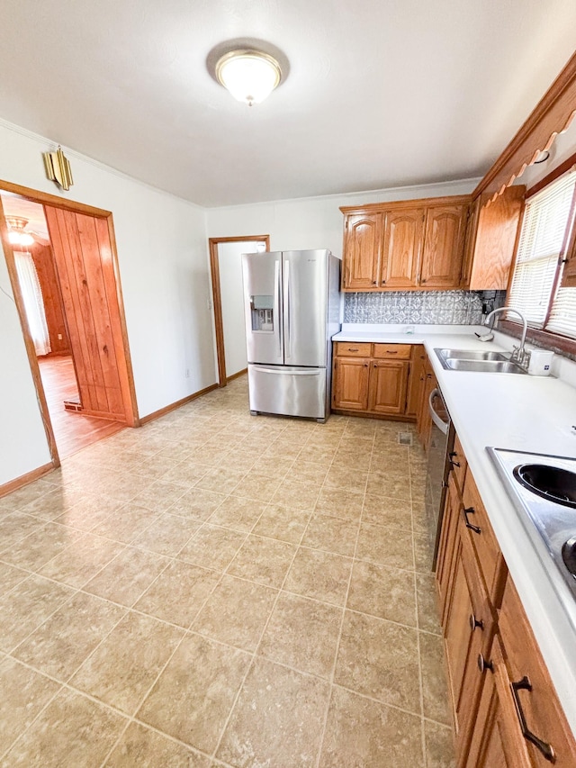 126 Zimmerman St, Hohenwald, TN 38462 - kitchen featuring decorative backsplash, light countertops, stainless steel appliances, a sink, and brown cabinetry