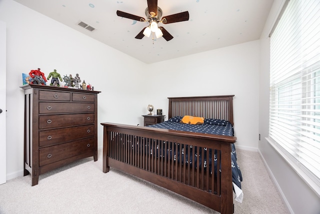 bedroom with baseboards, multiple windows, light carpet, and visible vents