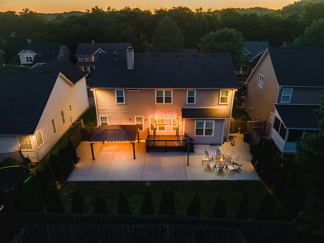back of property featuring a fenced backyard, a patio area, and a chimney