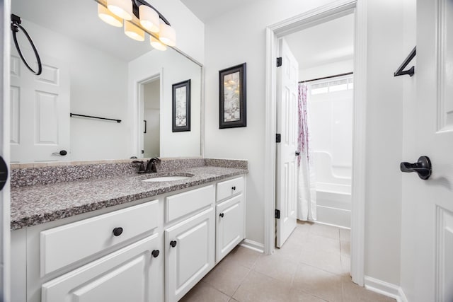 full bathroom featuring tile patterned floors, baseboards, shower / bath combo, and vanity