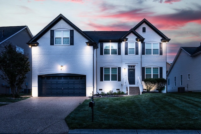 view of front of home featuring a front lawn, brick siding, central AC unit, an attached garage, and driveway