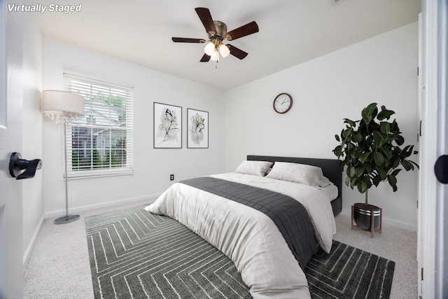 bedroom with baseboards, carpet flooring, and a ceiling fan