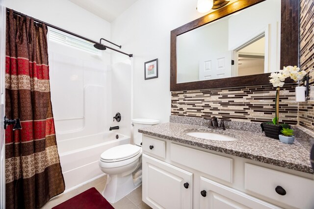bathroom featuring vanity, decorative backsplash, shower / tub combo with curtain, toilet, and tile patterned floors