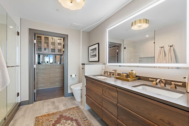 515 Church St Unit 3908, Nashville, TN 37219 - full bathroom with a stall shower, toilet, double vanity, and baseboards