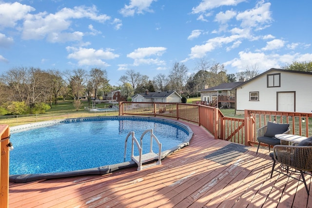 pool featuring a wooden deck and a residential view