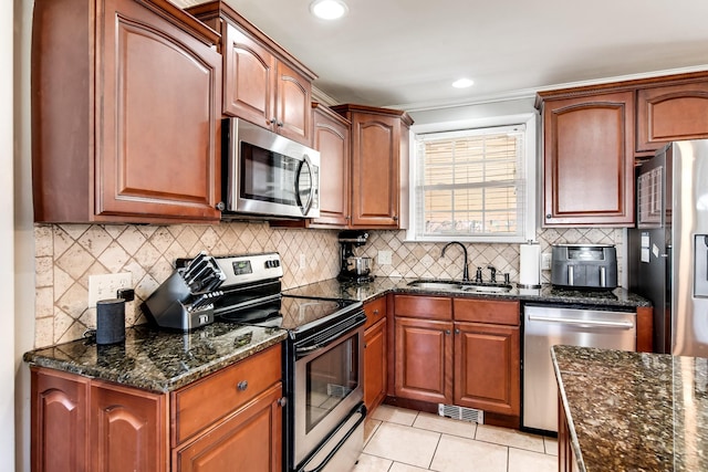 272 N Wessington Pl, Hendersonville, TN 37075 - kitchen featuring light tile patterned flooring, visible vents, appliances with stainless steel finishes, dark stone countertops, and a sink