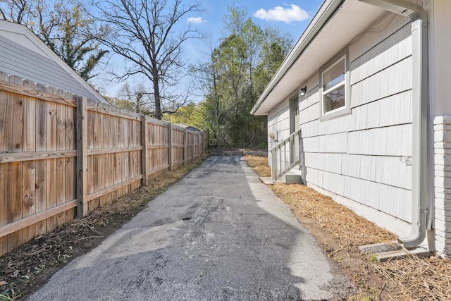 view of side of home featuring fence