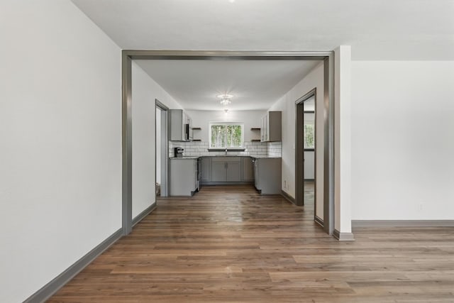 hall featuring baseboards and wood finished floors