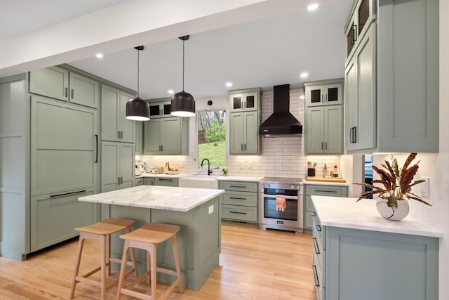 1122 Oman Dr, Brentwood, TN 37027 - kitchen featuring wall chimney range hood, green cabinets, oven, decorative backsplash, and light wood-type flooring